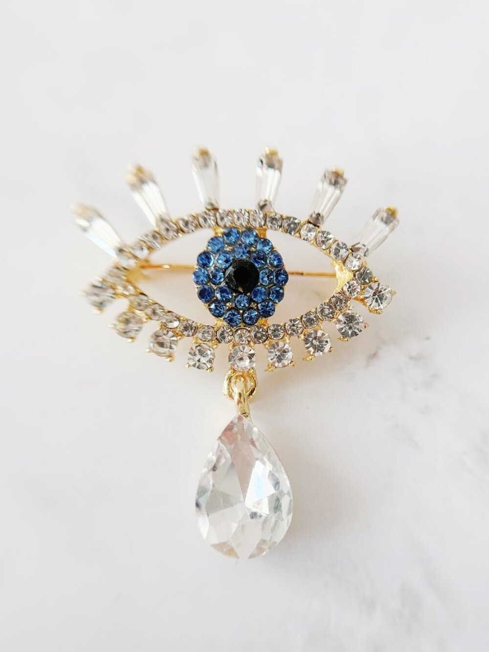Gold-Tone Blue Evil Eye Brooch with Rhinestones and a Clear Teardrop
